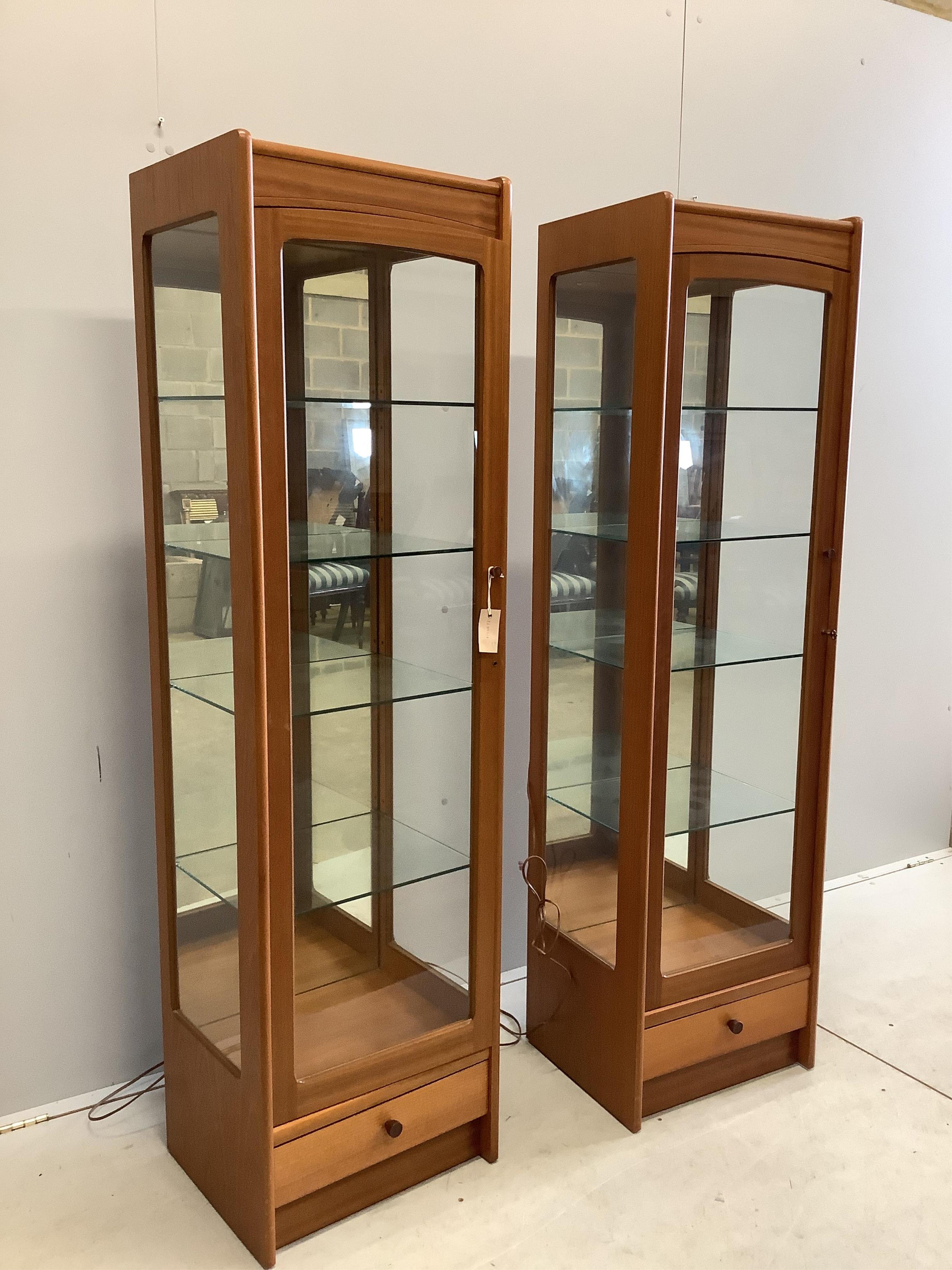 A pair of Parker Knoll teak display cabinets, width 46cm, depth 38cm, height 165cm. Condition - good